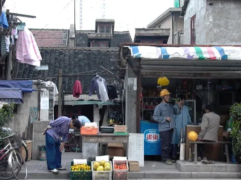 Workers gathered around a small roadside food stall