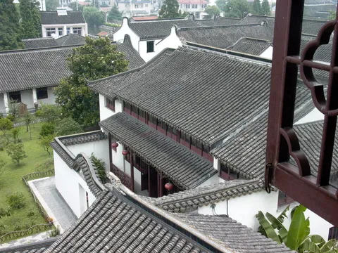 View from an upper window over tiled rooftops and a courtyard