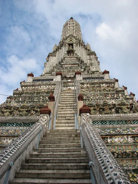 A steep stone stairway leading up an ornate temple tower