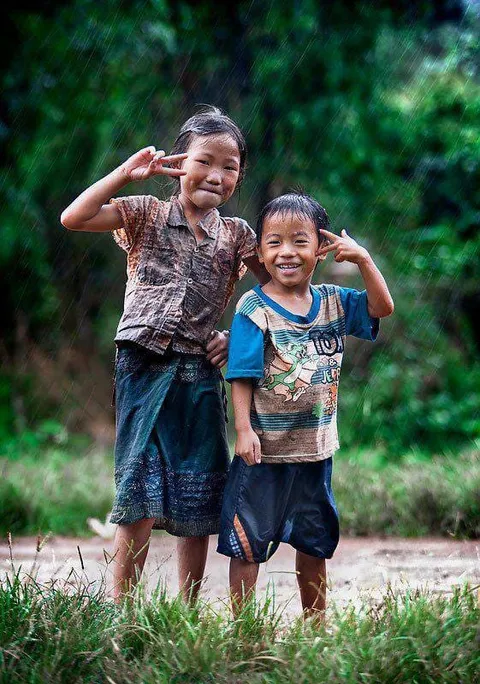 Two children smiling and posing together outdoors