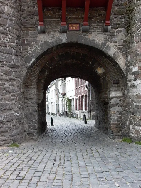 A stone gateway opening onto a paved street