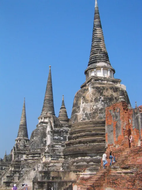 Weathered pointed temple spires on raised brick platforms