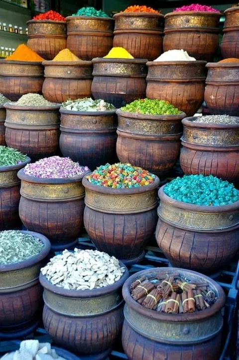 Baskets of brightly coloured goods stacked at a market stall