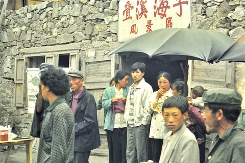 A group of men standing outside a stone building