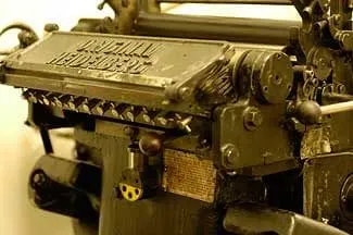 Close-up of a metal printing machine bearing the name Original Heidelberg