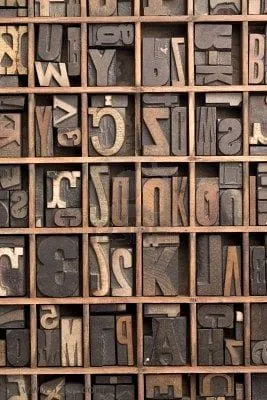 Wooden printing letters arranged in a divided type case