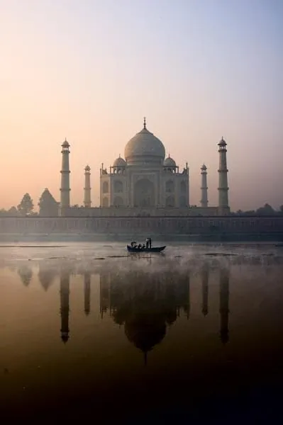 The Taj Mahal reflected in water in the evening light
