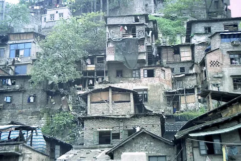 Small hillside houses rising in layers above tiled rooftops